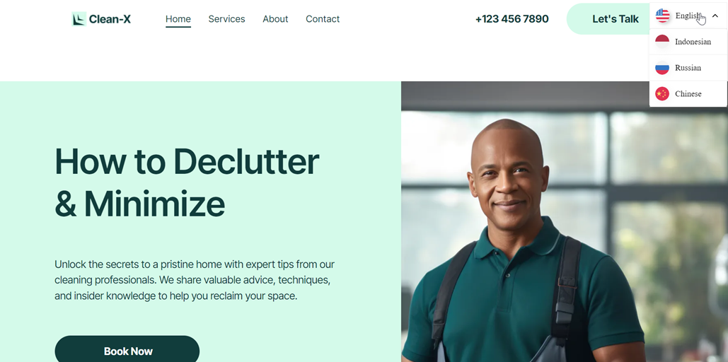 Smiling man in green shirt standing in front of window