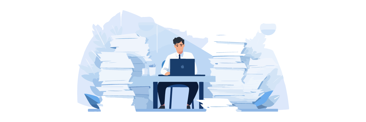 Man working on laptop surrounded by papers. Business and productivity concept.