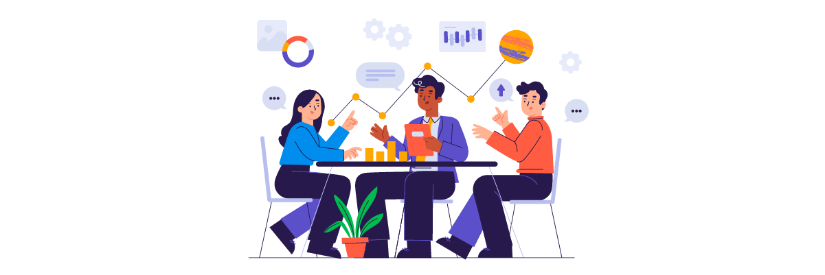 Three people sitting at a table looking at graphs and charts. They appear to be in a meeting discussing business strategy.