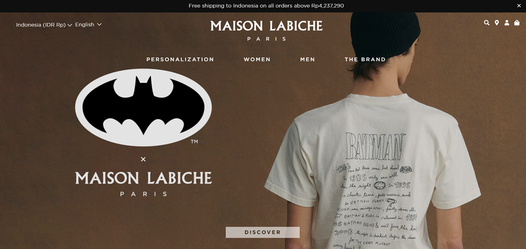 Maison Labiche Paris fashion brand logo on brown background. Man wearing white t-shirt with Batman design.