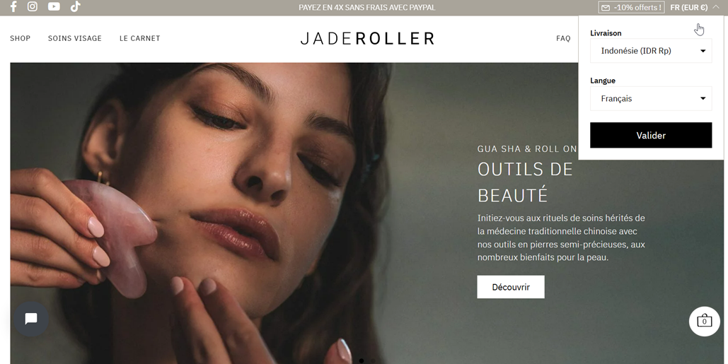 Woman with closed eyes using a jade roller. Beauty tool for facial massage.