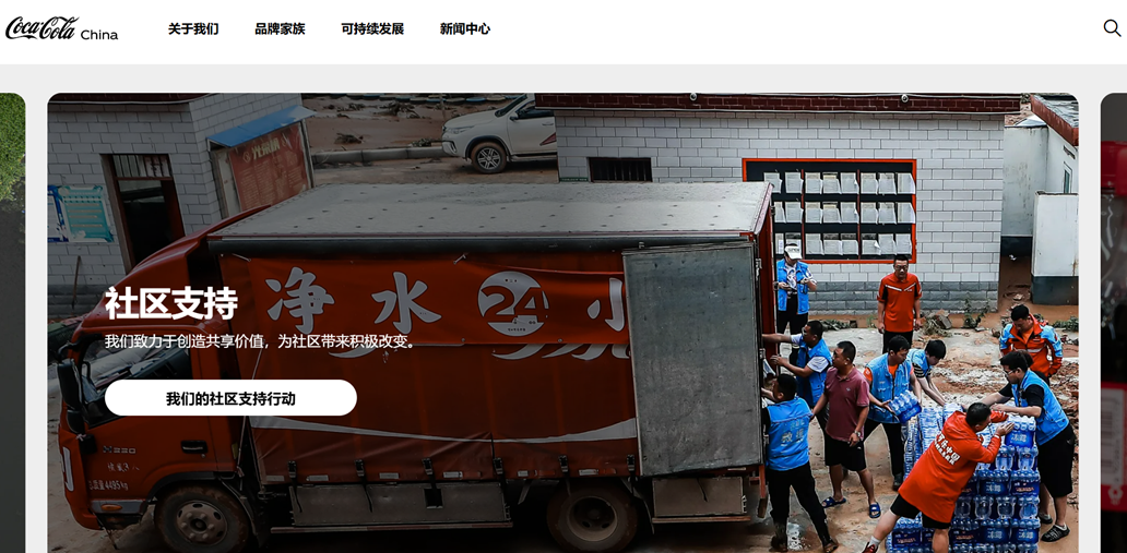 People in blue shirts unloading water bottles from truck. Volunteers helping with delivery.